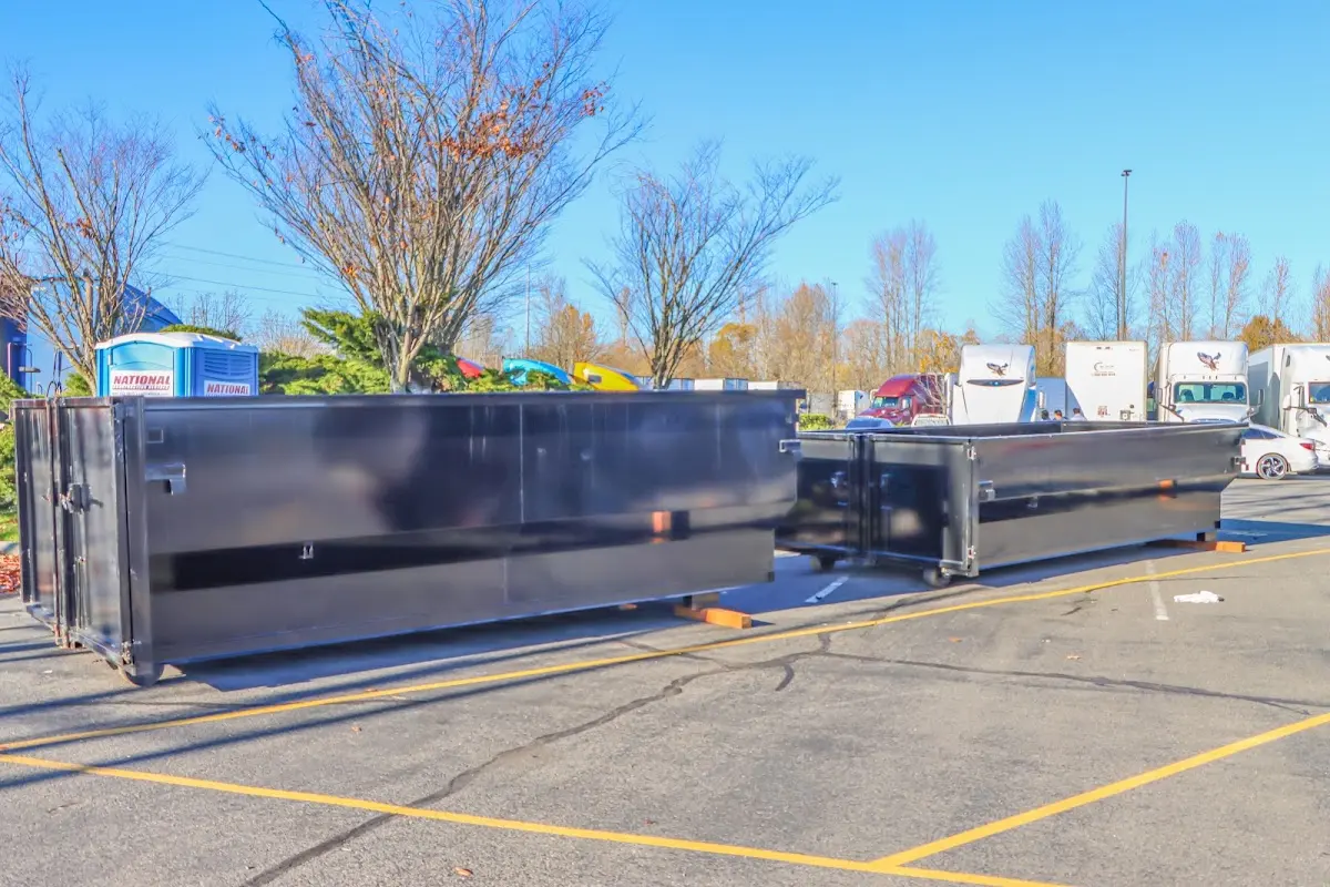 Professional dumpster rental service with roll-off container on residential driveway in Kendall West
